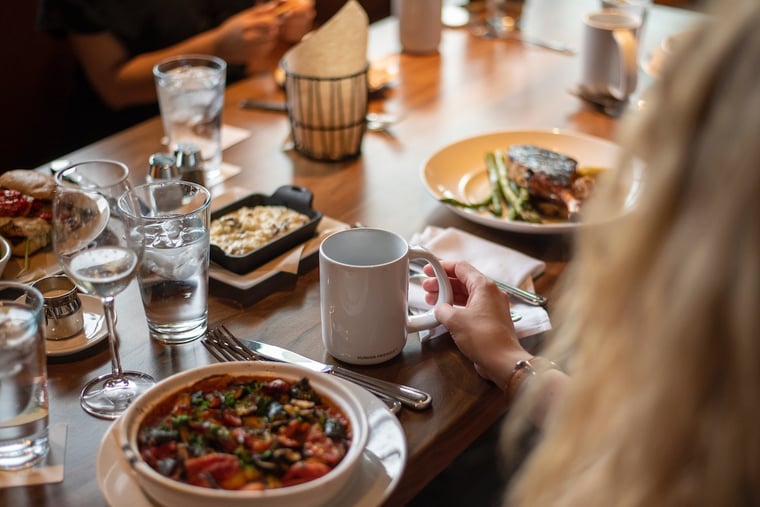 Woman sitting with a dish in a restaurant