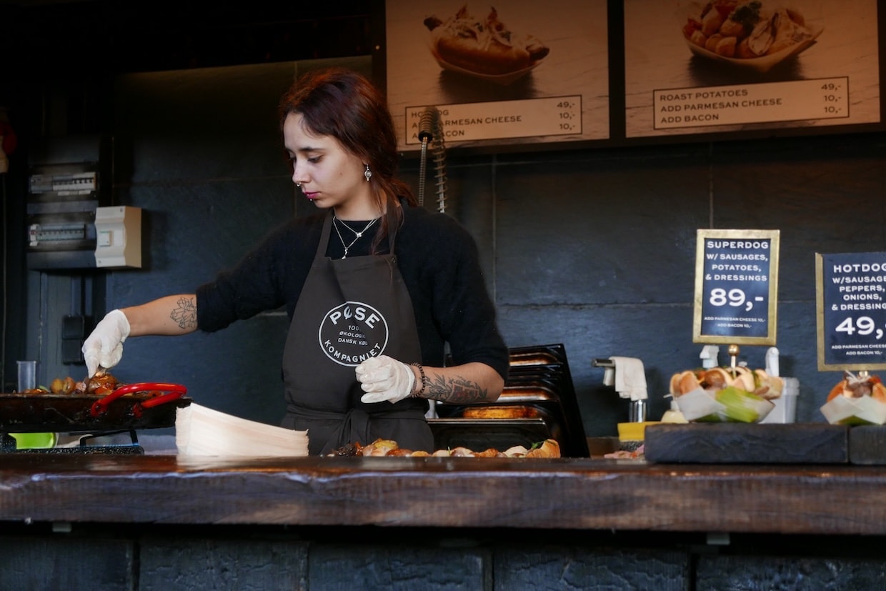 Employee in a food truck prepares food