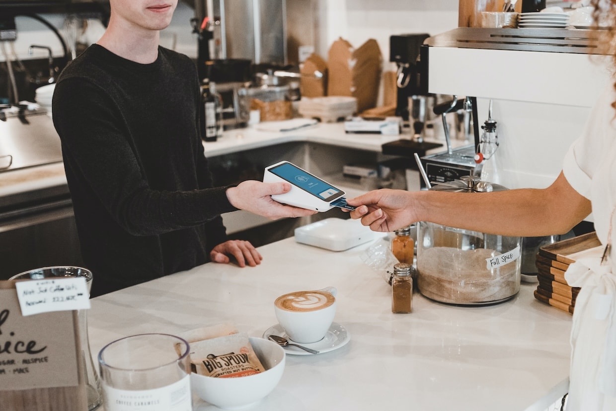 Customer pays with a card in a café