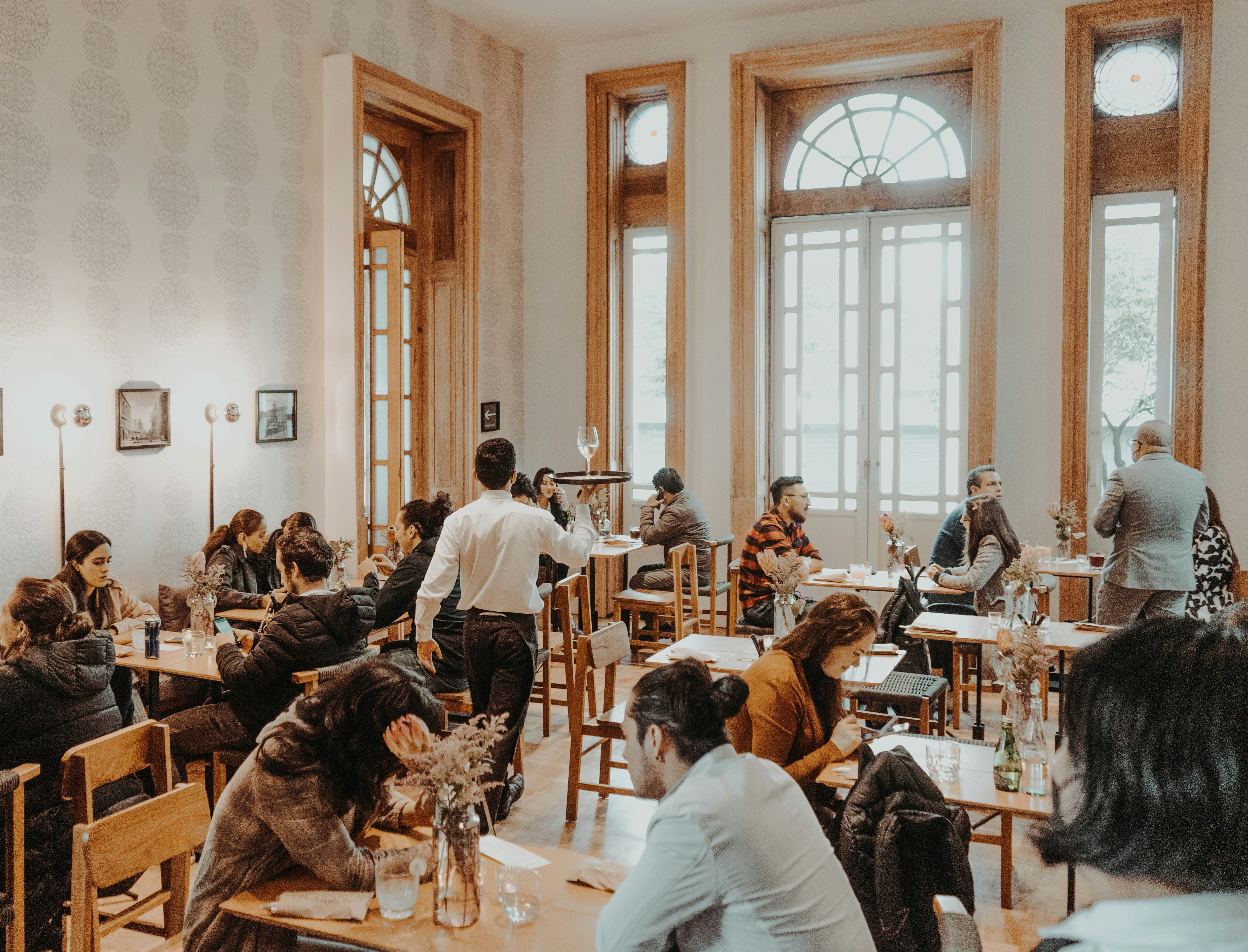 full restaurant with guests and a server