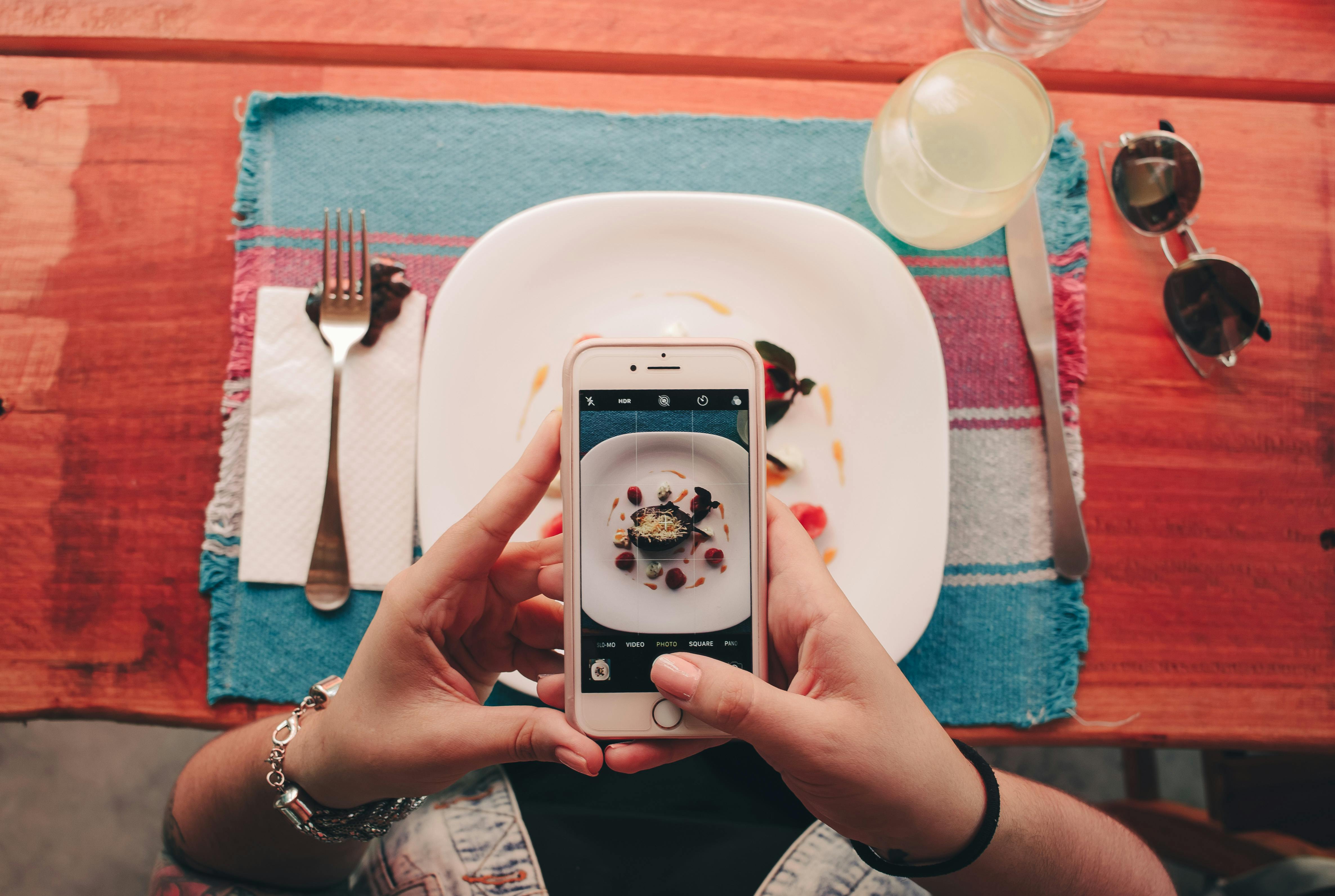 Guest takes photo of dish with smartphone
