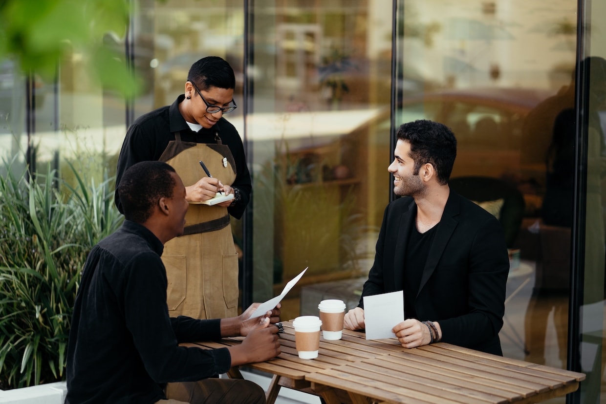 Waiter takes order from two guests in a restaurant