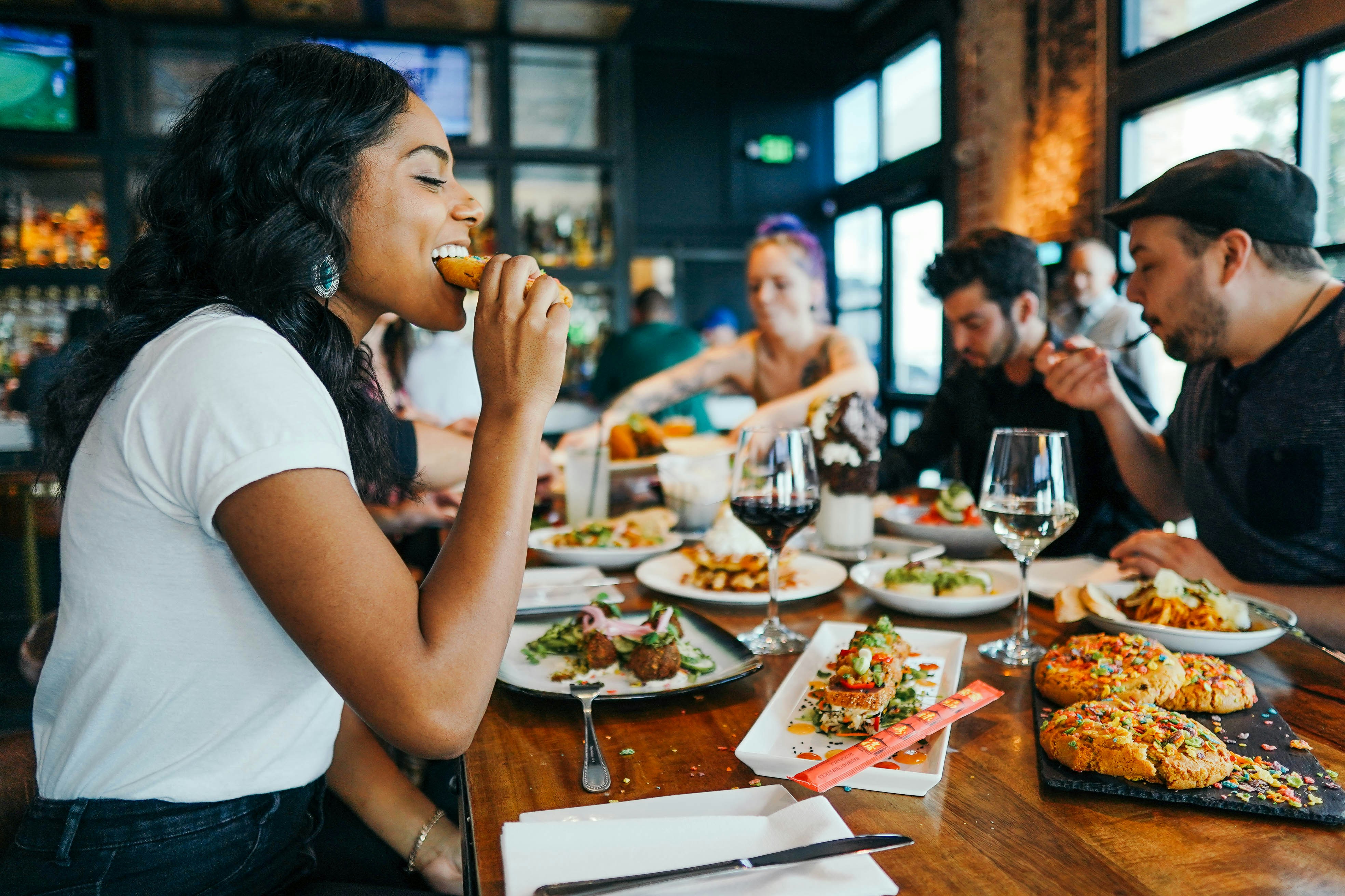 A customer who is eating at a table with a group of friends.