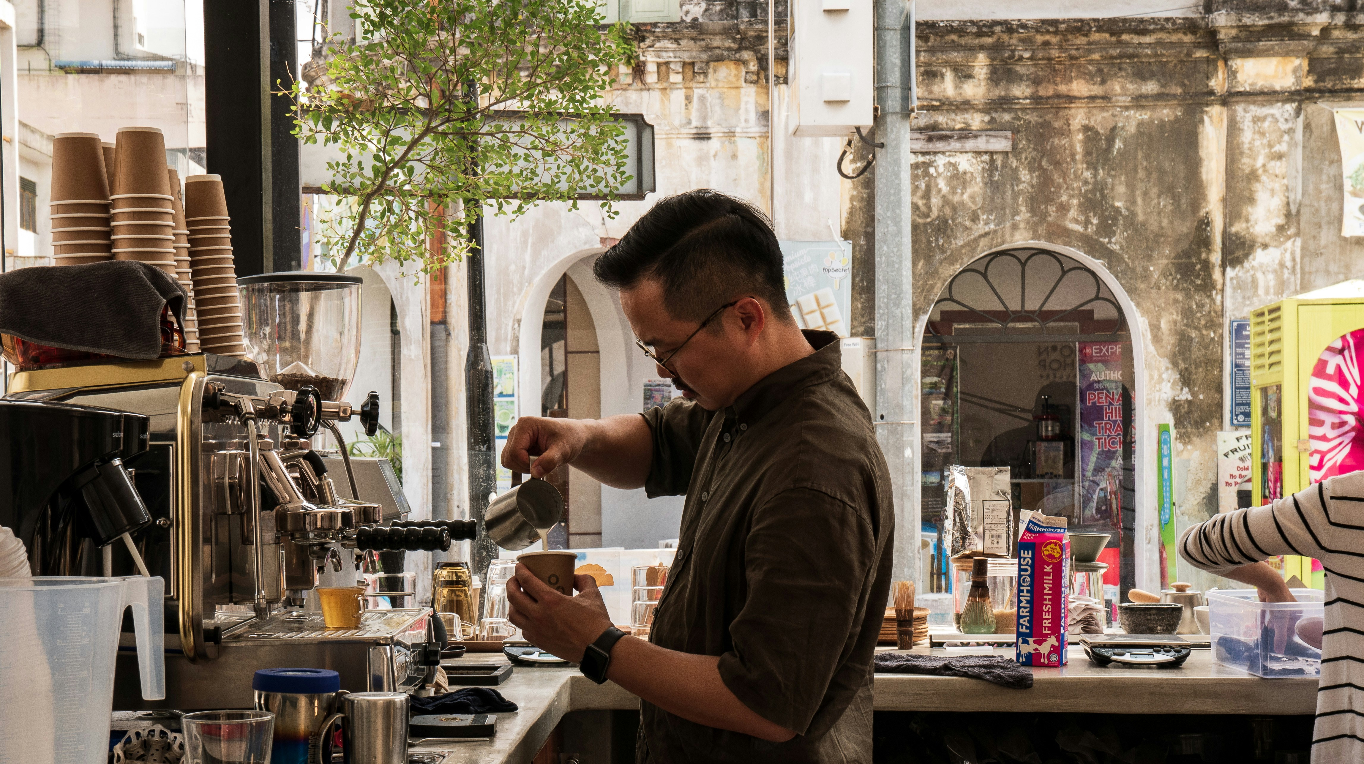 Employee prepares coffee behind the counter