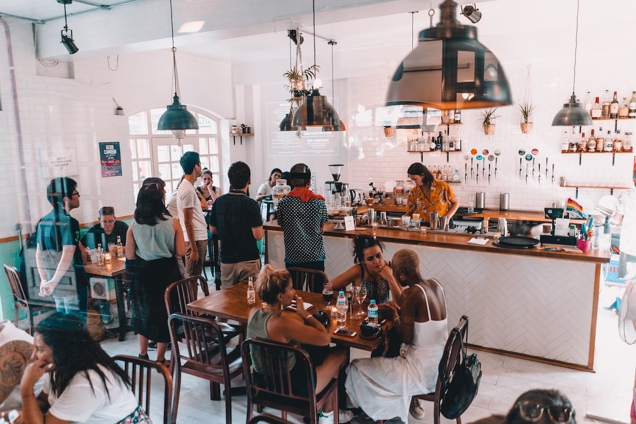 Small café with customers and employee