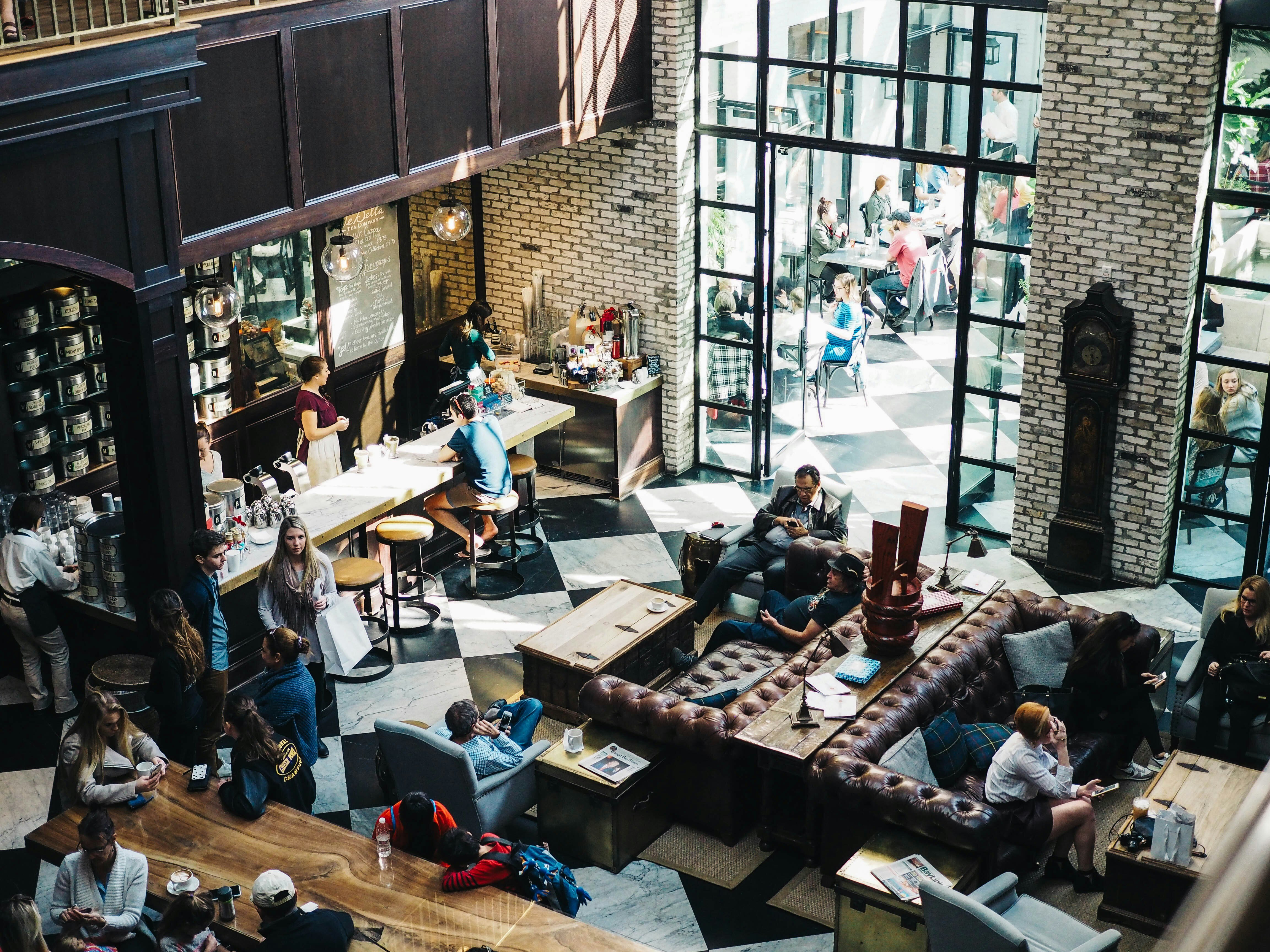 A cozy café with many guests and employees.