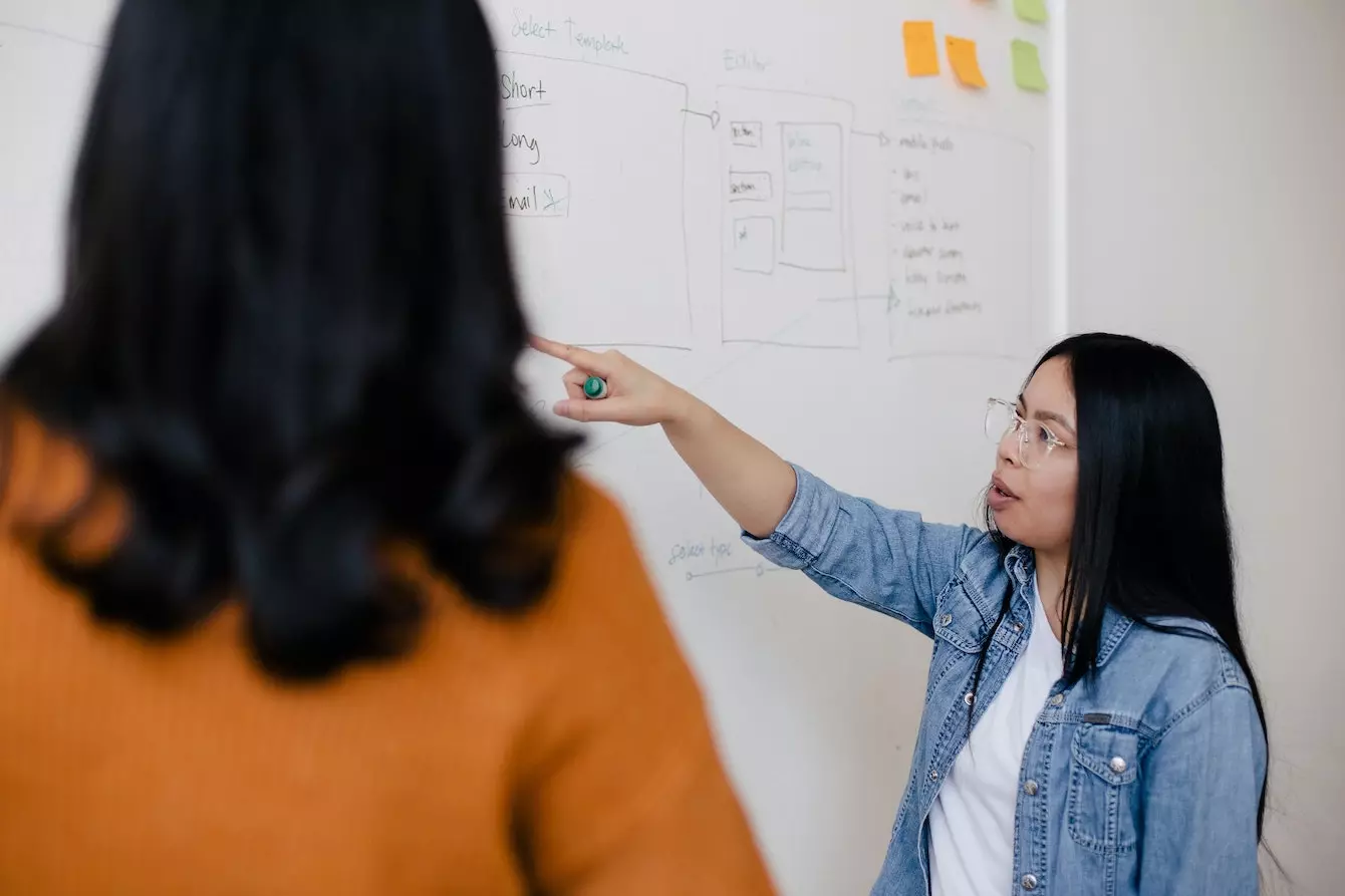 Image of woman pointing at whiteboard